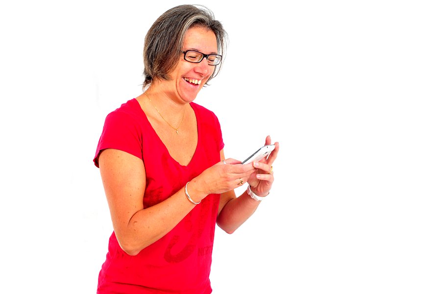 Woman in red t shirt on smartphone in studio