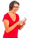 Woman in red t shirt on smartphone in studio