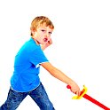 Young boy in studio playing with sword on white background