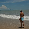 Stock photo of beautiful tall brunette woman on the beach in the tropics