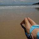 Stock photo of beautiful tall brunette woman on the beach in the tropics