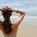 Stock photo of beautiful tall brunette woman on the beach in the tropics